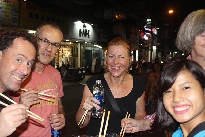 Food Tour by motorbike with local students - Riding through Saigon after dark