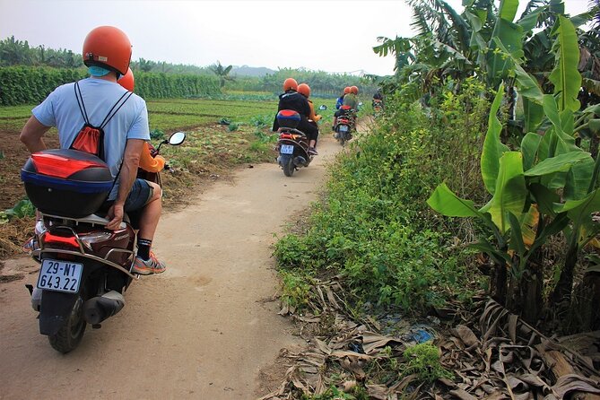 Hanoi Motorbike Tours Led By Women: Hanoi City Insight Motorbike Tours - Hanoi landmarks seen from the road