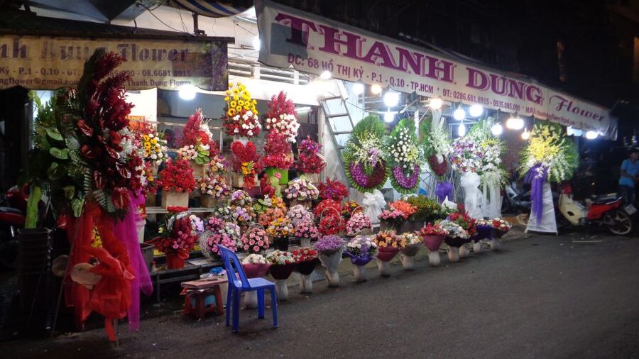 Midnight Street Food Tour In Saigon By Motorbike - Flowers under the lights at Saigon’s night market