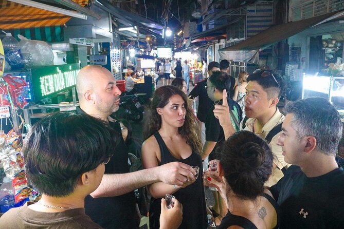 Private Discover Saigon Hidden Spots on Night Motorbike Adventure - A Vietnamese baguette, beer, and a taste of local routine